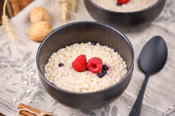 Still life with oatmeal and fresh raspberries. Useful breakfast.