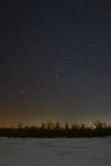 Obraz na płótnie Canvas Stars in the night sky over the frozen river Don in Russia.