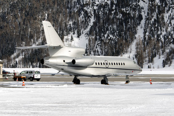 A private jet in the airport of St Moritz in the alps switzerland in winter