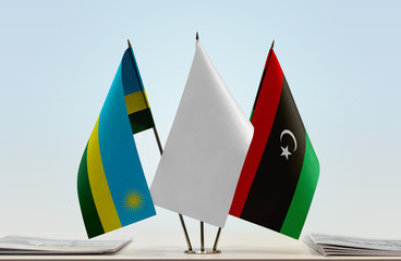 Flags of Rwanda and Libya with a white flag in the middle