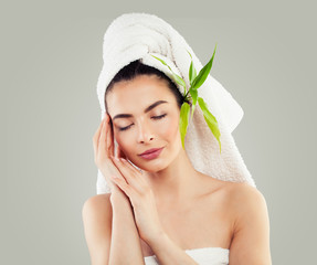 Spa Model Woman with Healthy Skin, White Towel and Green Bamboo Leaves. Skincare Concept