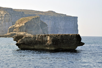 Rocks on the Maltese island of Gozo with the sea in the background