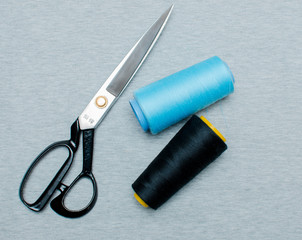 Scissors, centimeter. Multicolored thread coils. The concept of sewing.