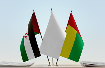 Flags of Sahrawi Arab Democratic Republic and Guinea-Bissau with a white flag in the middle