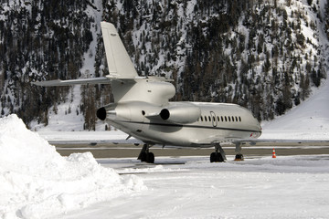 A private jet in the airport of St Moritz in the alps switzerland in winter