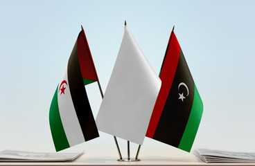 Flags of Sahrawi Arab Democratic Republic and Libya with a white flag in the middle