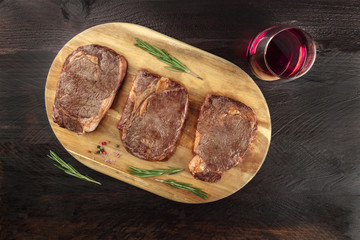 Cooked meat on rustic textures with wine and copyspace