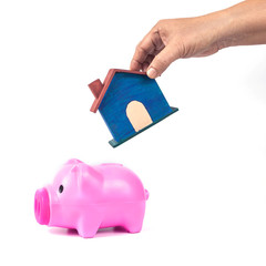 piggy bank with small house in save for home concept .