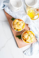 Homemade italian bread casserole strata with cheese, egg and ham, white background copy space  top view