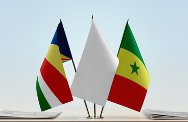 Flags of Seychelles and Senegal with a white flag in the middle