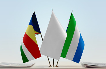 Flags of Seychelles and Sierra Leone with a white flag in the middle