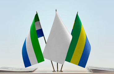 Flags of Sierra Leone and Gabon with a white flag in the middle