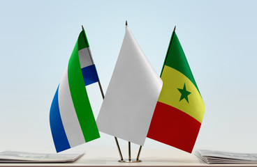 Flags of Sierra Leone and Senegal with a white flag in the middle