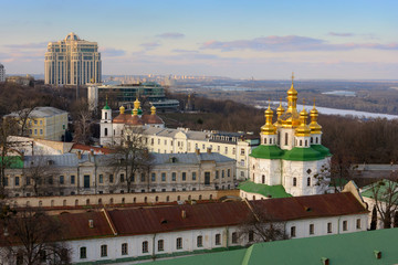 Fototapeta na wymiar Kyiv landscape with Kiev Pechersk Lavra structures, modern buildings and Dnieper river on background.