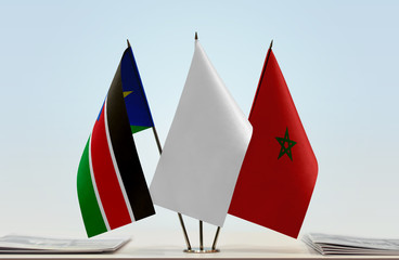 Flags of South Sudan and Morocco with a white flag in the middle