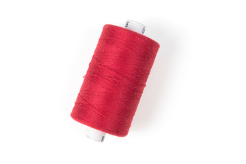 Red sewing thread on a white background