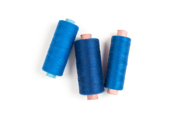 Three Blue sewing threads on a white background