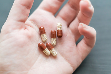medicine transparent capsules in woman hand