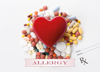 ALLERGY written on heart and medication background