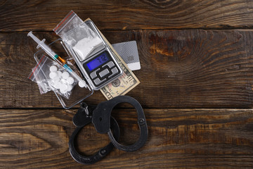 Illegal drugs, money and handcuffs