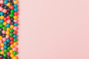 top view of arranged candies isolated on pink