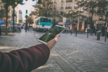 Woman using cellphone and crossing the street.