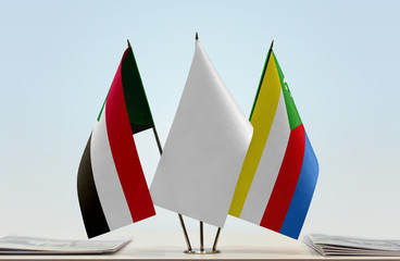 Flags of Sudan and Comoros with a white flag in the middle