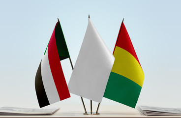 Flags of Sudan and Guinea with a white flag in the middle