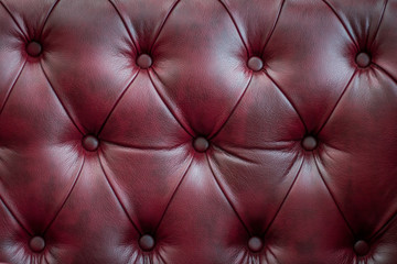 Closeup texture of vintage red leather sofa for background