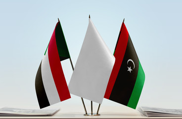 Flags of Sudan and Libya with a white flag in the middle