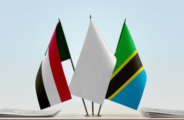 Flags of Sudan and Tanzania with a white flag in the middle