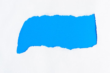torn white paper on a blue background copyspace for message
