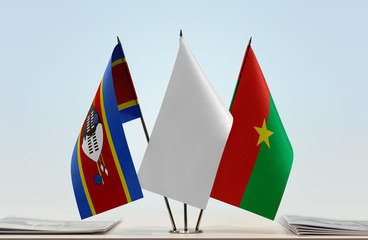 Flags of Swaziland and Burkina Faso with a white flag in the middle