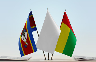 Flags of Swaziland and Guinea-Bissau with a white flag in the middle