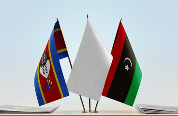 Flags of Swaziland and Libya with a white flag in the middle