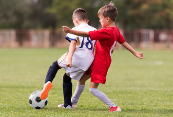 Obraz premium Young children players football match on soccer field