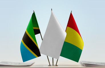 Flags of Tanzania and Guinea with a white flag in the middle