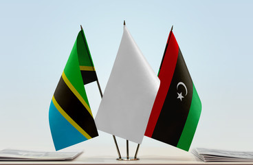 Flags of Tanzania and Libya with a white flag in the middle