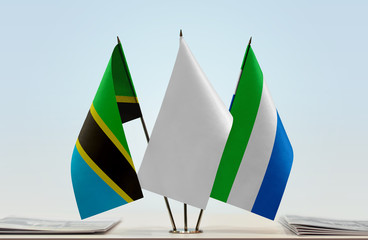 Flags of Tanzania and Sierra Leone with a white flag in the middle