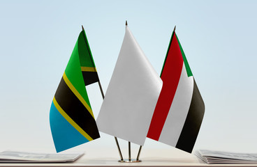 Flags of Tanzania and Sudan with a white flag in the middle