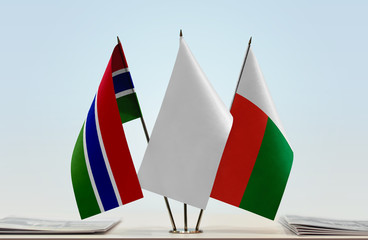 Flags of The Gambia and Madagascar with a white flag in the middle