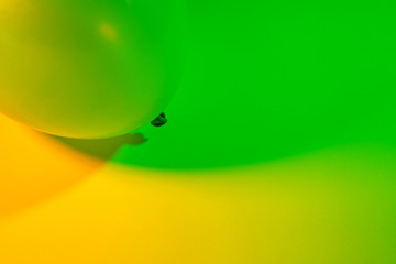 Simple abstract single air balloon color gradient background made by two colorful lights transitioning into each other. Green and yellow.