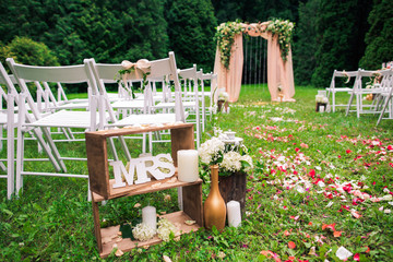 Beautiful place made with wooden square and floral roses decorations for outside wedding ceremony...