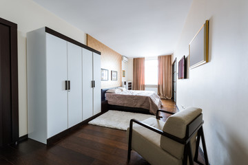 close up view of arranged stylish bedroom with closet and bed