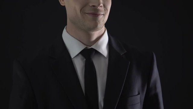 Income tax inspector taking bribe, covering up illegal business, smirk close up
