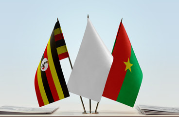 Flags of Uganda and Burkina Faso with a white flag in the middle