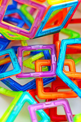abstract background of geometric shapes, colored plastic toys, magnetic constructor