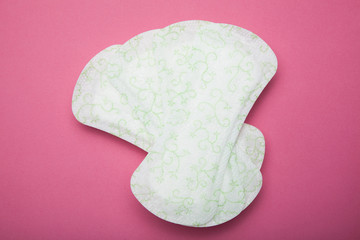 Set of white cotton hygienic napkins on a pink background, menstrual cycle.