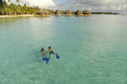 Woman and man snorkeling in the sea in Bora Bora