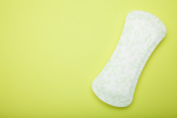 White soft and comfort sanitary napkin pad on green background. Copy space.